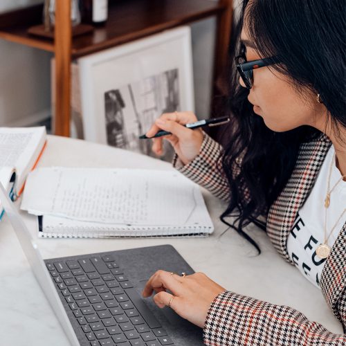 Woman studying and taking notes