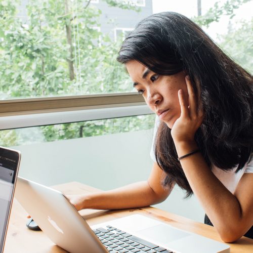 Woman reading on a laptop